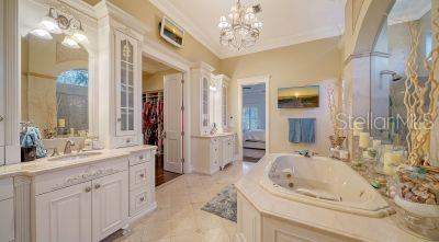 5309 Hidden Harbor Road Sarasota, FL 34242 - Photo 40 of 88 a bathroom with a sink double vanity granite tub shower and a mirror