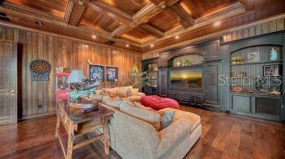 5309 Hidden Harbor Road Sarasota, FL 34242 - Photo 55 of 88 a living room with furniture and a flat screen tv