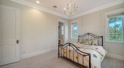 5309 Hidden Harbor Road Sarasota, FL 34242 - Photo 59 of 88 a view of a bedroom with a bed and a chandelier