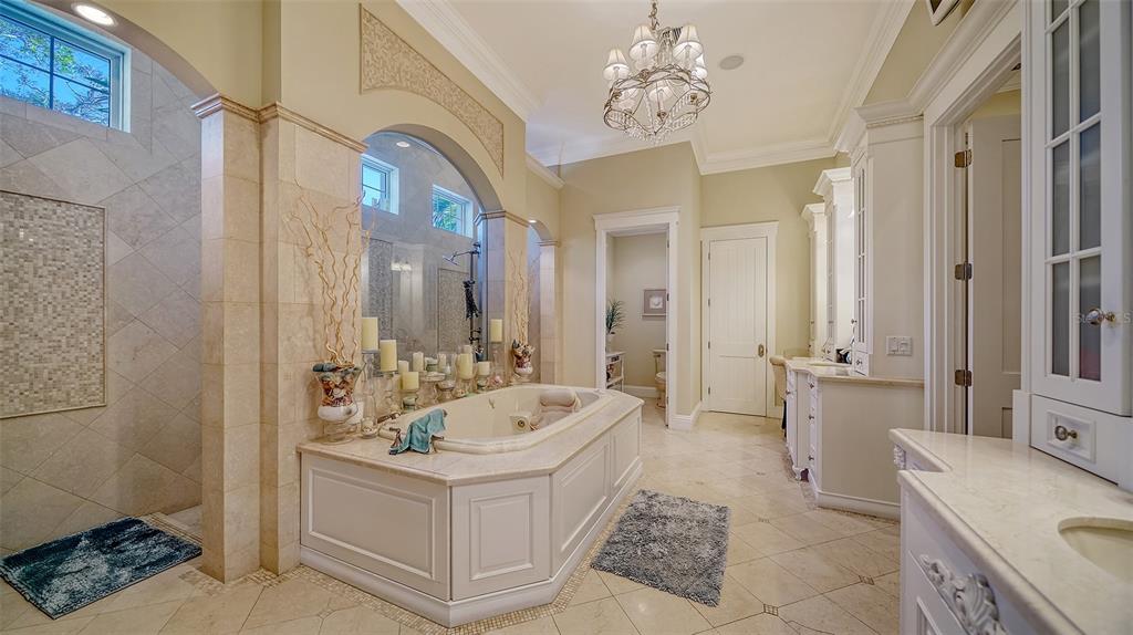 5309 Hidden Harbor Road Sarasota, FL 34242 - Photo 60 of 100 a bathroom with a tub sink a mirror and a shower