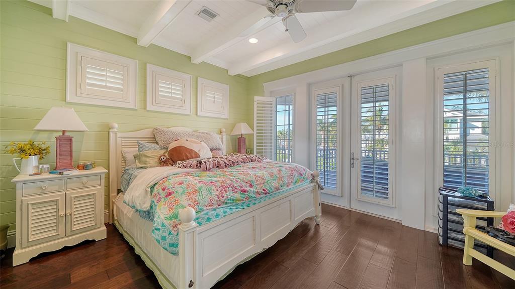 5309 Hidden Harbor Road Sarasota, FL 34242 - Photo 68 of 100 a bedroom with a bed and a chandelier