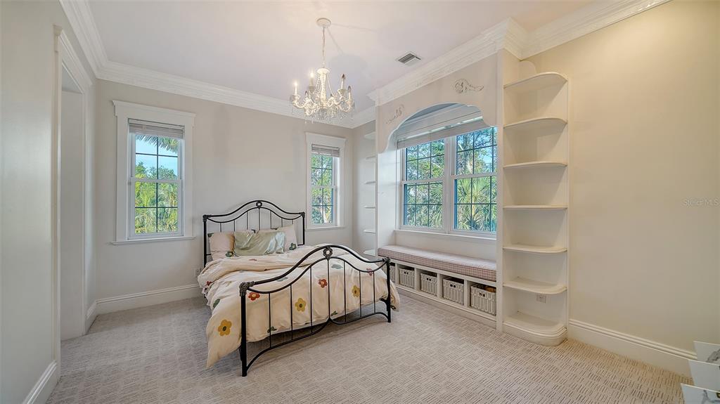 5309 Hidden Harbor Road Sarasota, FL 34242 - Photo 73 of 100 a bedroom with furniture and a chandelier