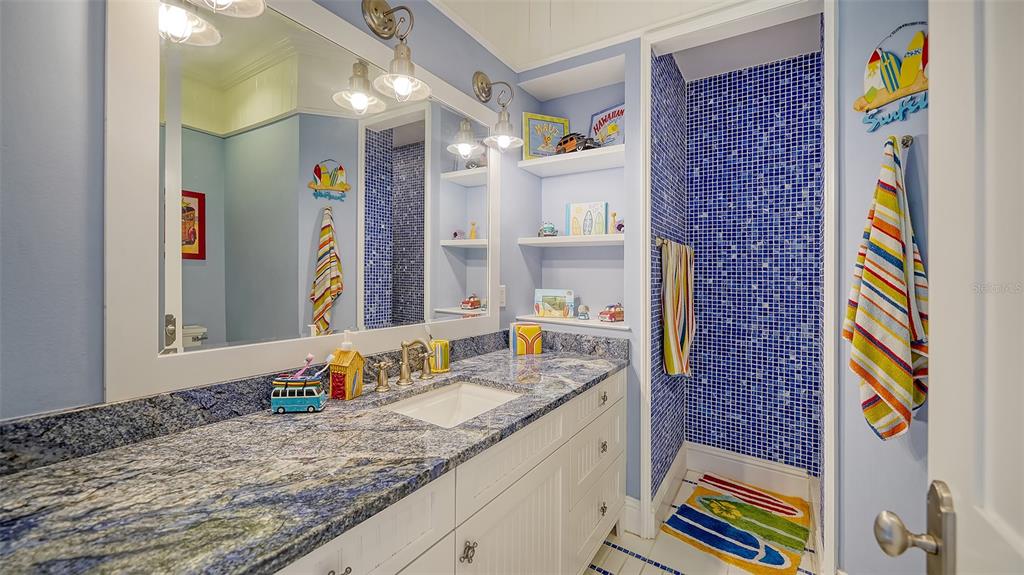 5309 Hidden Harbor Road Sarasota, FL 34242 - Photo 79 of 100 a bathroom with a granite countertop sink and a mirror
