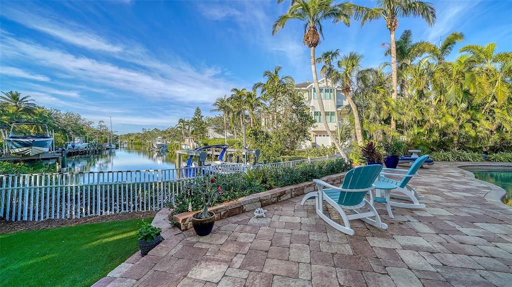 5309 Hidden Harbor Road Sarasota, FL 34242 - Photo 91 of 100 a view of a chairs and table in backyard
