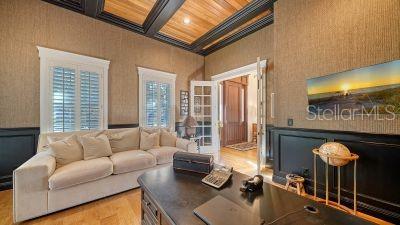 5309 Hidden Harbor Road Sarasota, FL 34242 - Photo 10 of 88 a living room with furniture and a floor to ceiling window