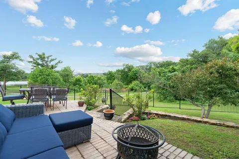 a view of a patio with couches chairs and a fire pit