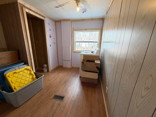 a view of room with window and wooden floor