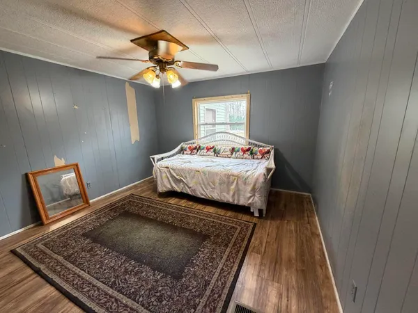 a bedroom with a bed and window