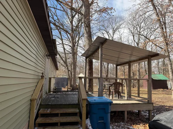 a view of a house with backyard and wooden roof