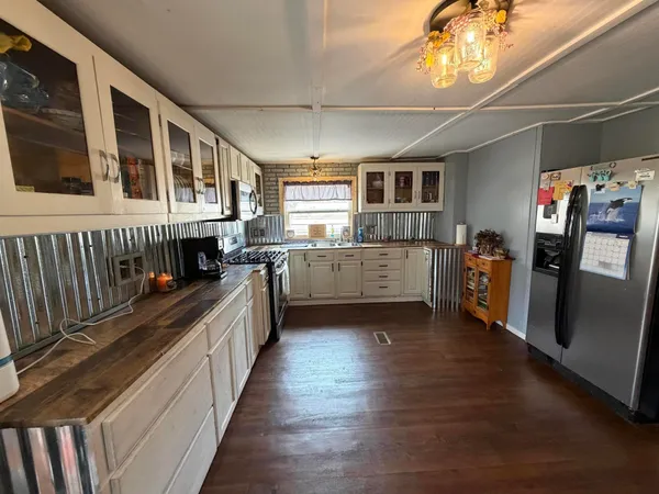 a kitchen with stainless steel appliances granite countertop a stove and a refrigerator