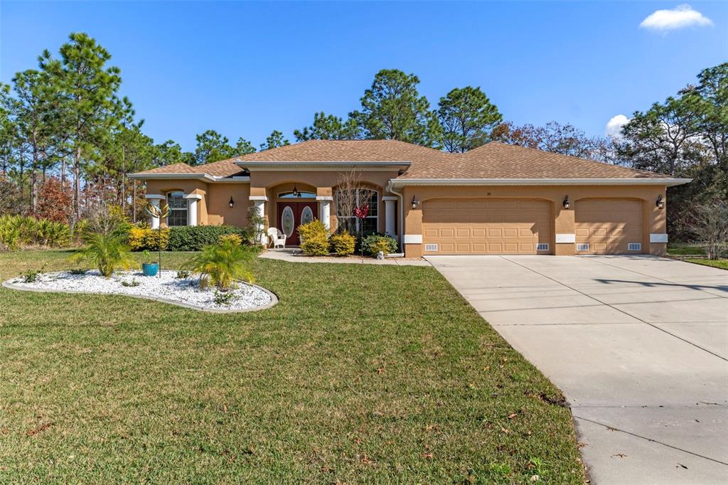 39 Linder Street Homosassa, FL 34446 - Photo 1 of 63 a front view of a house with garden