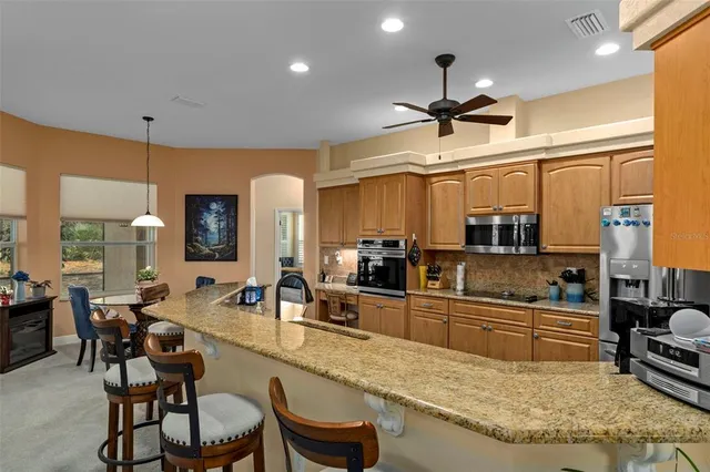 a kitchen with a sink appliances and cabinets