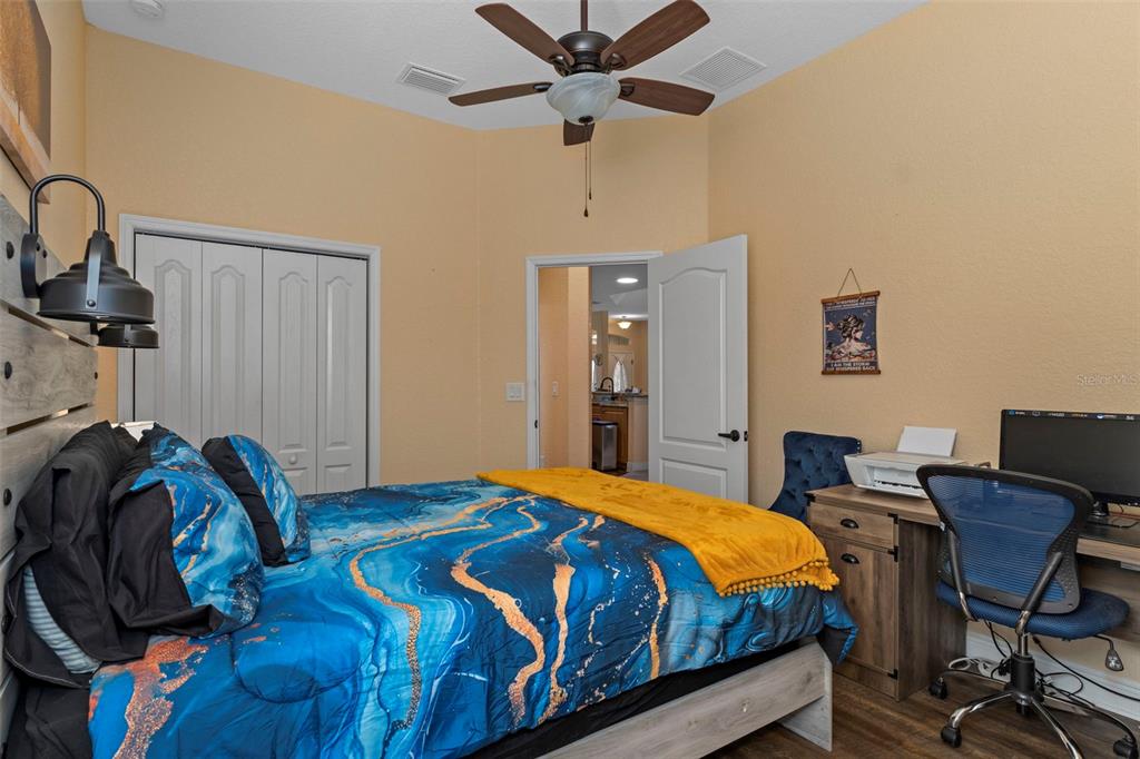 39 Linder Street Homosassa, FL 34446 - Photo 22 of 63 a bedroom with a bed and a desk