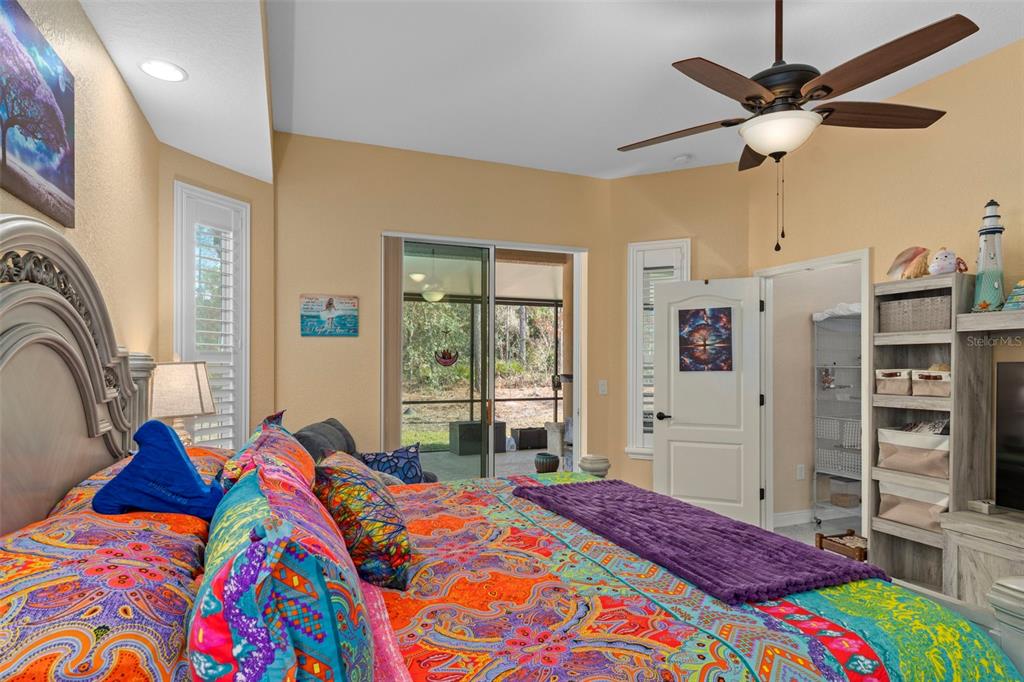 39 Linder Street Homosassa, FL 34446 - Photo 27 of 63 a bedroom with a bed and a chandelier