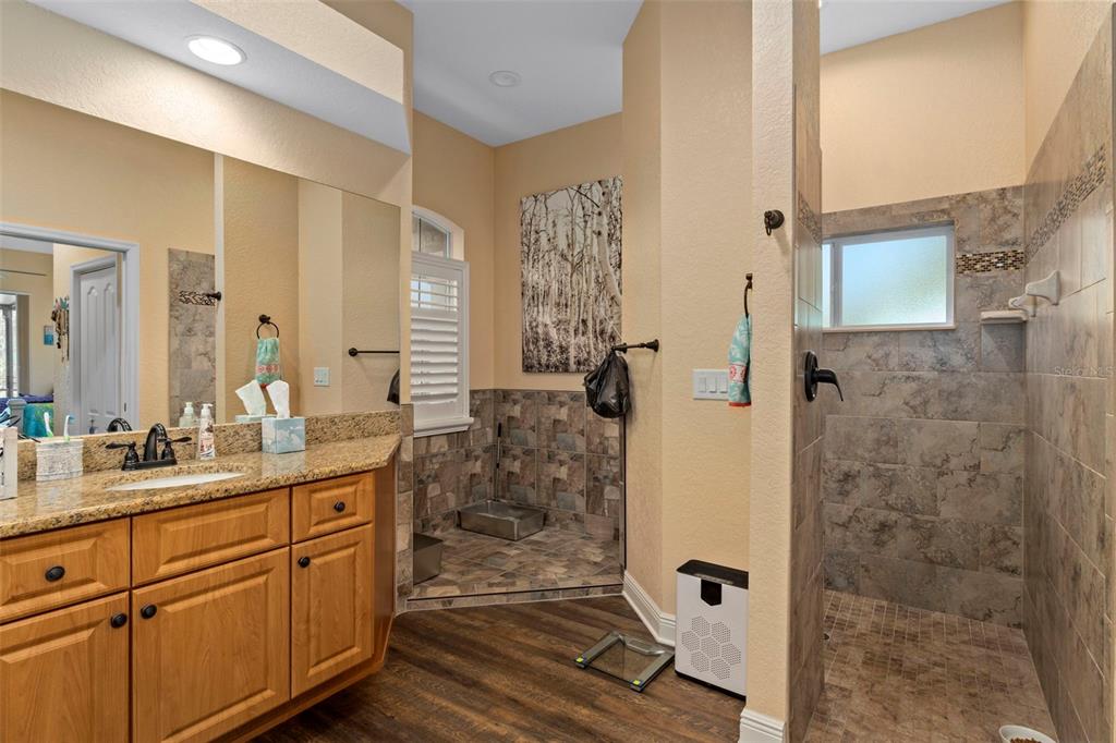 39 Linder Street Homosassa, FL 34446 - Photo 31 of 63 a bathroom with a double vanity sink mirror and shower