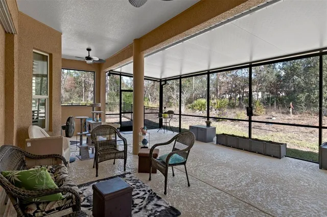 a view of a house with swimming pool and sitting area