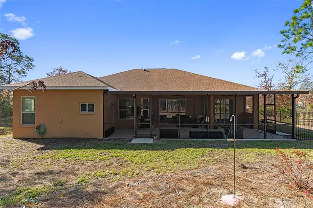 an aerial view of a house with a yard and garden