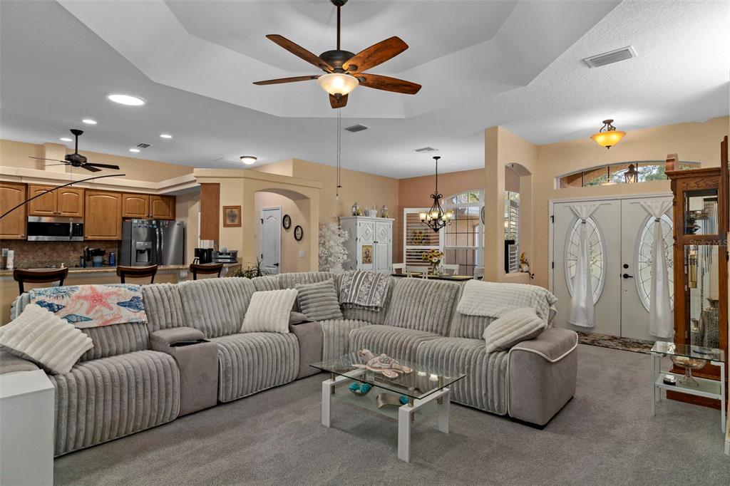 39 Linder Street Homosassa, FL 34446 - Photo 9 of 63 a living room with furniture kitchen view and a chandelier