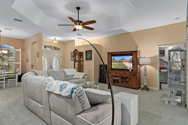 a view of a dining room with furniture and chandelier