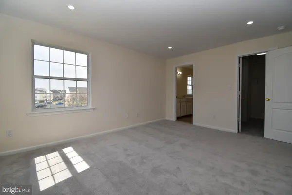 a bathroom with a granite countertop sink a toilet and a mirror