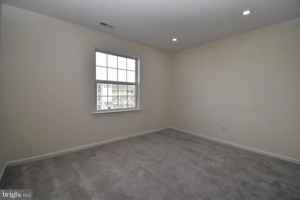 an empty room with closet area