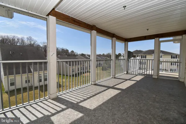 a view of a balcony with yard