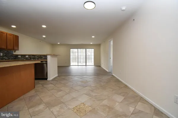 a view of kitchen with stainless steel appliances granite countertop a refrigerator and a sink