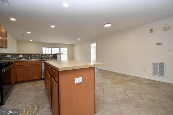 a view of kitchen with stainless steel appliances granite countertop refrigerator sink and microwave