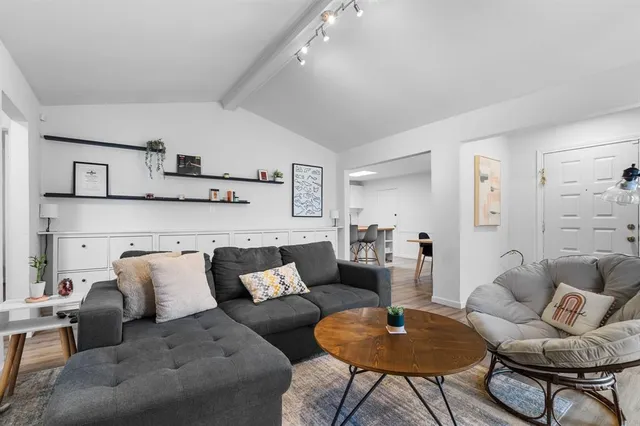 a living room with furniture and a rug