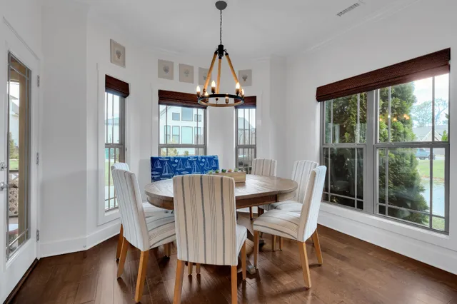 a view of a dining room with furniture wooden floor and a chandelier