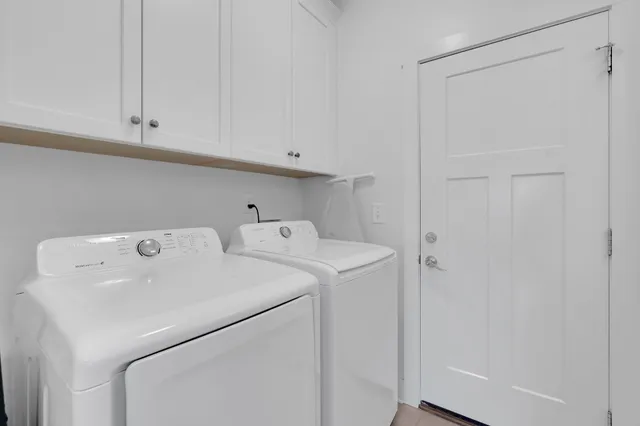 a view of a patio with couches table and chairs and potted plants