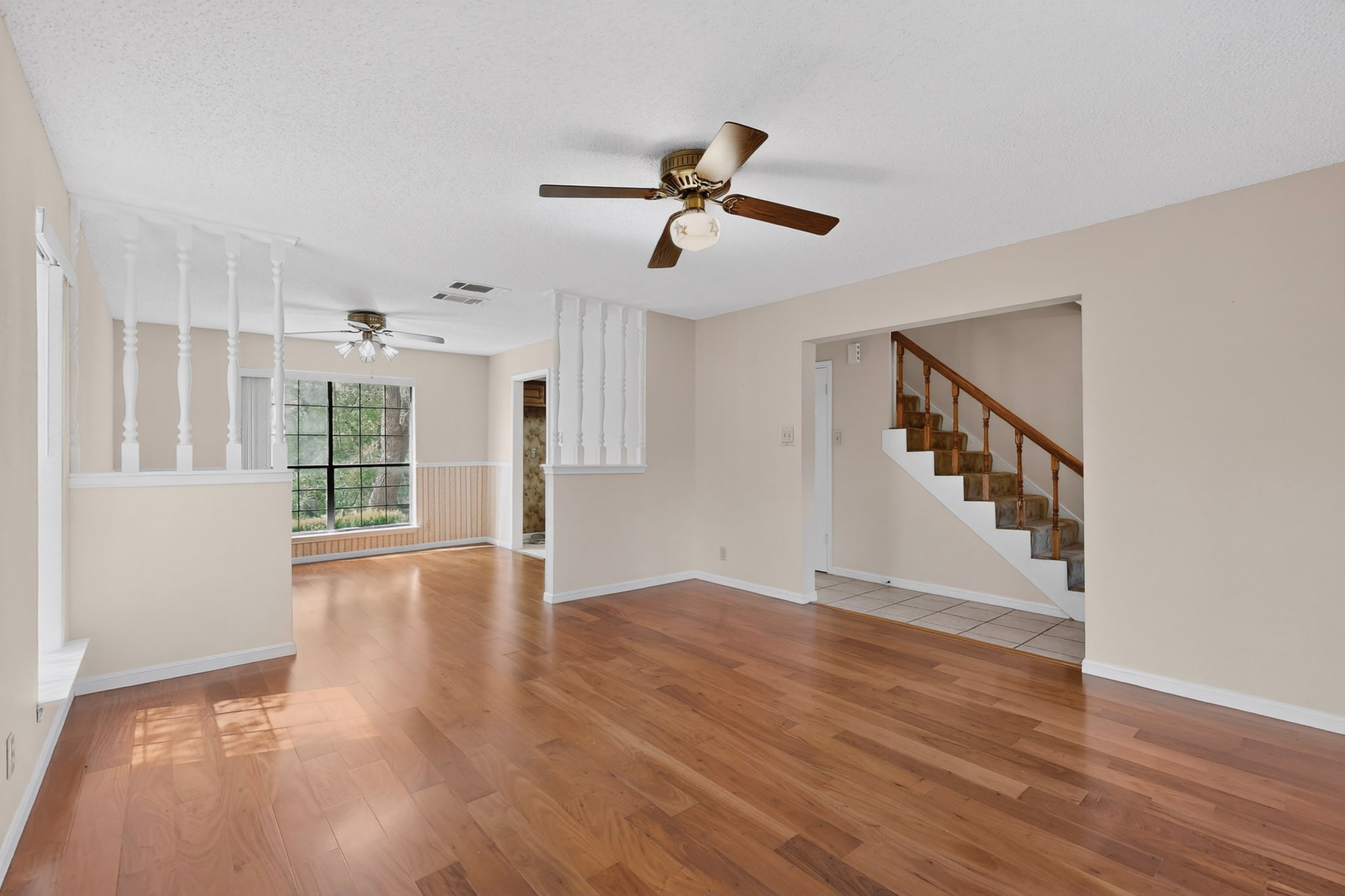 1003 Pier Branch Road Dripping Springs, TX 78620 - Photo 16 of 40 Hardwood flooring extends throughout this generous living space, offering an elegant foundation.