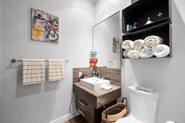 a bathroom with a sink mirror and vanity