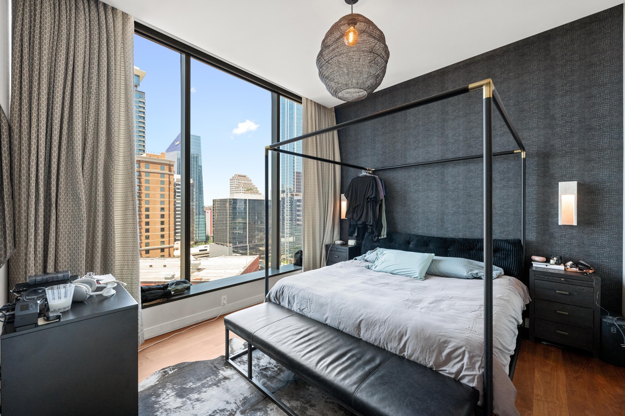 210 Lavaca Street, Unit 1911 Austin, TX 78701 - Photo 6 of 18 a bedroom with a large bed and wooden floor