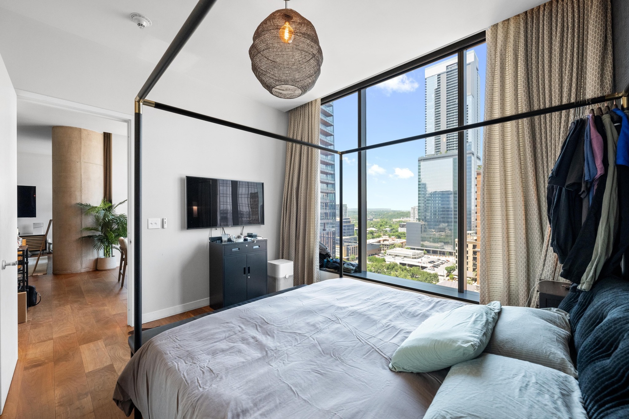 210 Lavaca Street, Unit 1911 Austin, TX 78701 - Photo 7 of 18 a bedroom with furniture and a large window