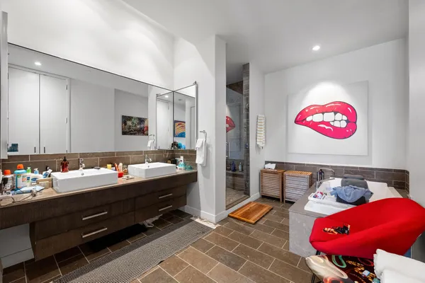 a bedroom with furniture and a large window