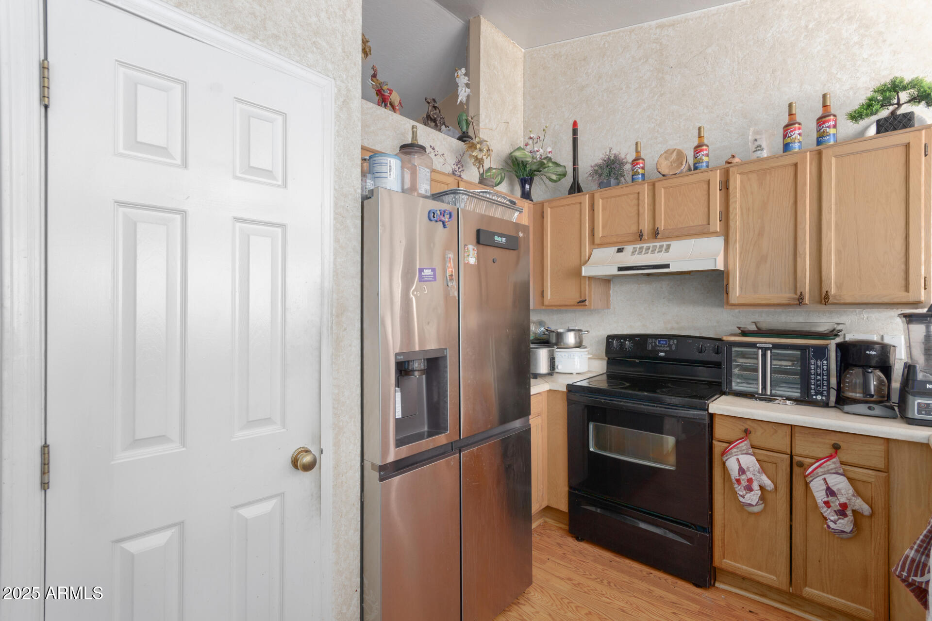 1704 South 39th Street, Unit 24 Mesa, AZ 85206 - Photo 10 of 20 a kitchen with stainless steel appliances granite countertop a stove a refrigerator and a wooden cabinets