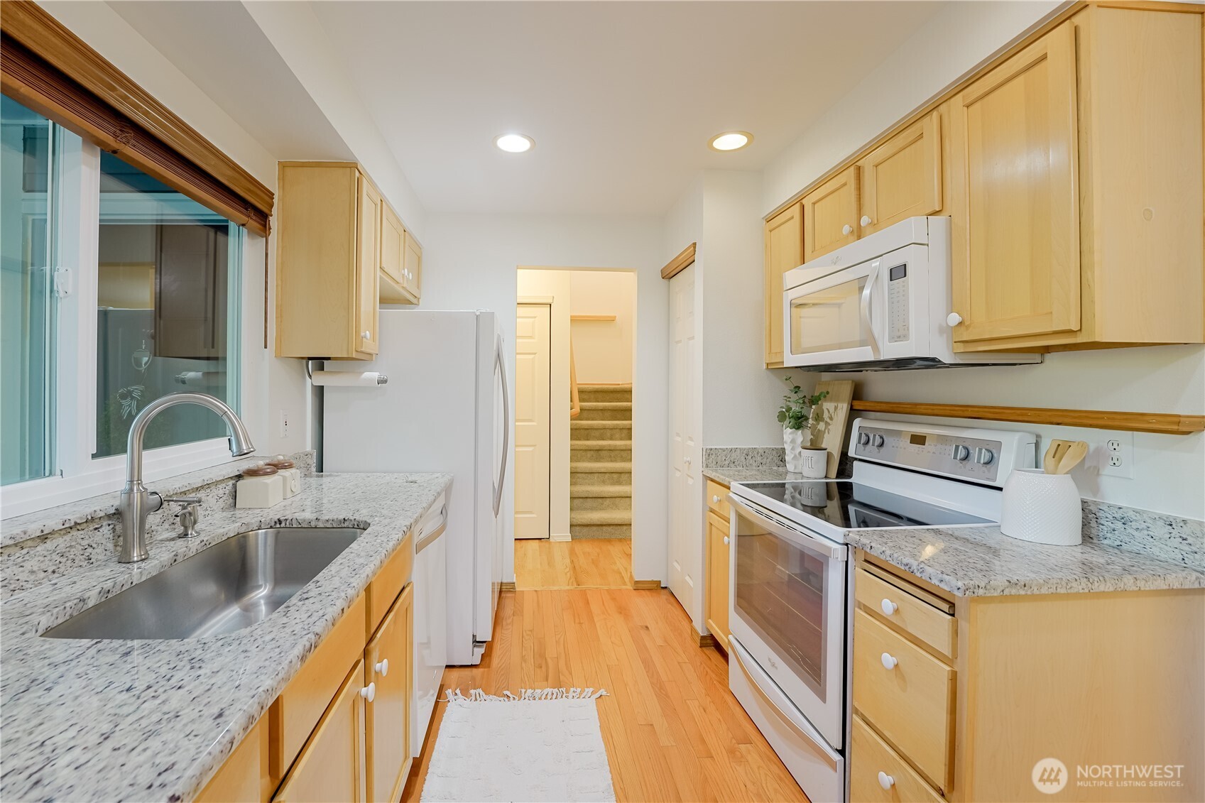 2201 192nd Street Southeast, Unit P4 Bothell, WA 98012 - Photo 13 of 28 a kitchen with stainless steel appliances granite countertop a sink and a stove