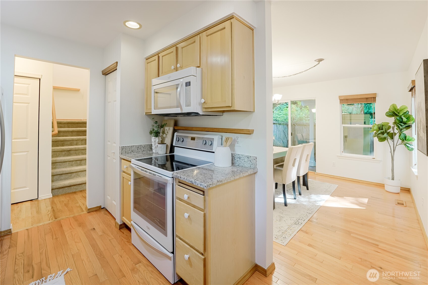 2201 192nd Street Southeast, Unit P4 Bothell, WA 98012 - Photo 14 of 28 a kitchen with granite countertop a stove and a wooden floor