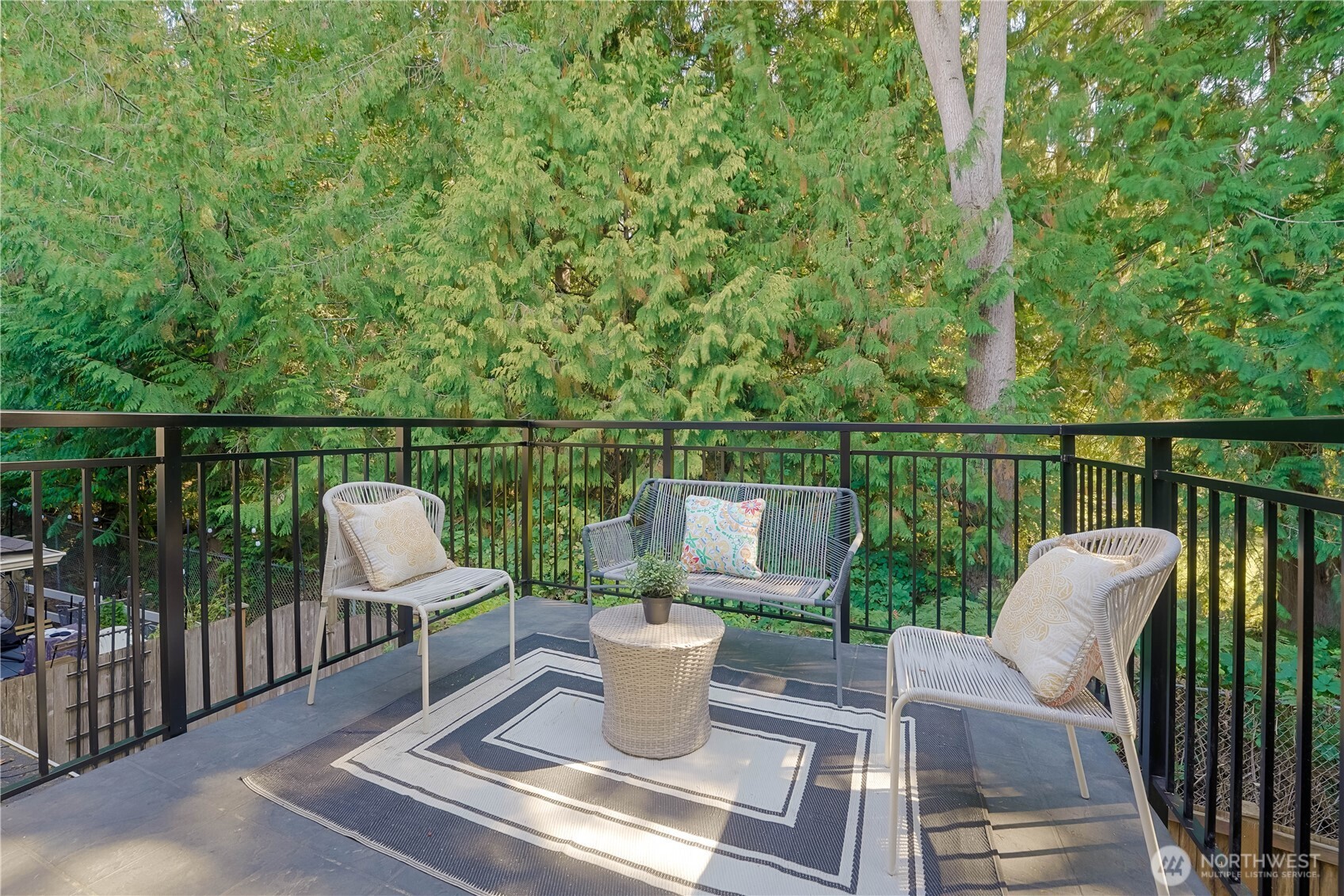 2201 192nd Street Southeast, Unit P4 Bothell, WA 98012 - Photo 20 of 28 a view of a deck with two chair and a potted plant