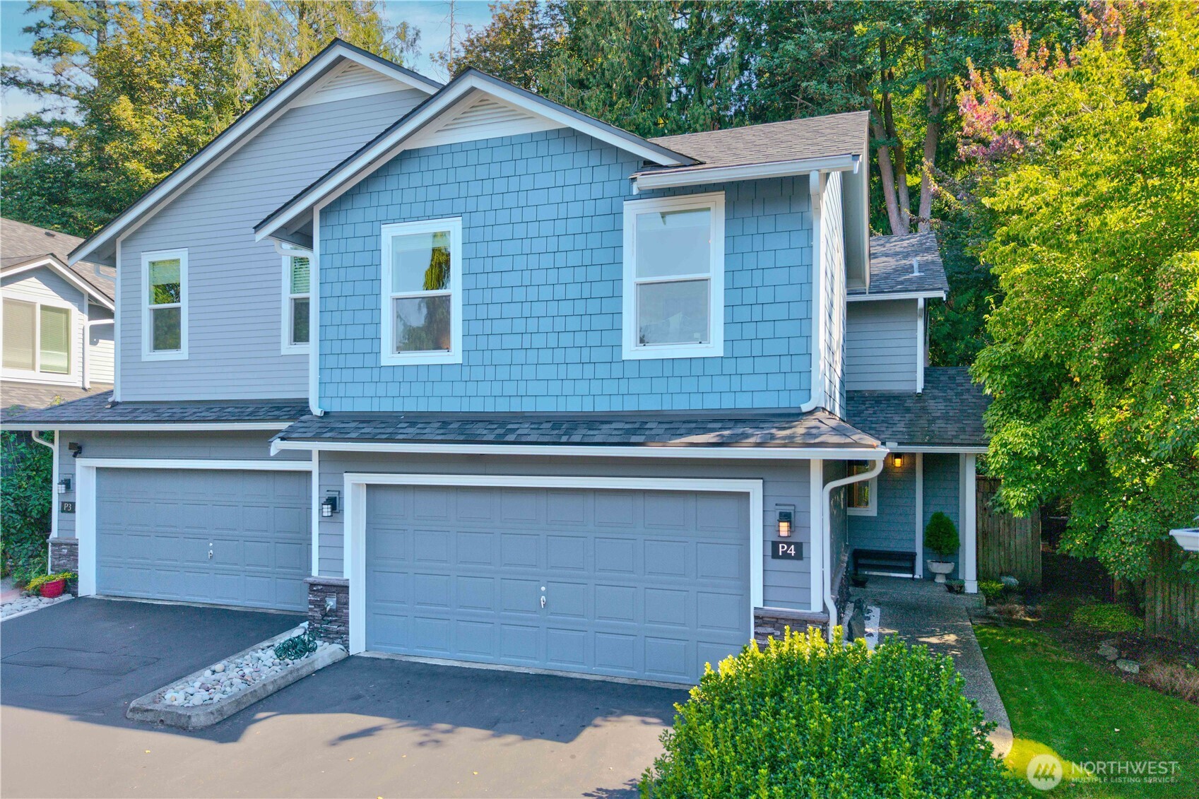 2201 192nd Street Southeast, Unit P4 Bothell, WA 98012 - Photo 2 of 28 a front view of a house with a yard and garage