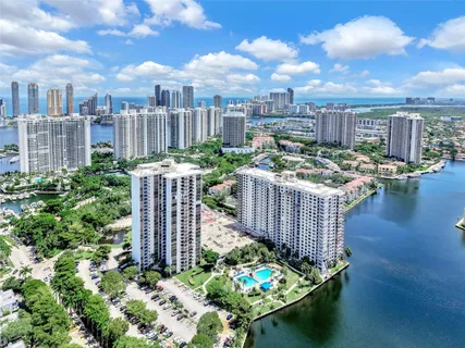 a view of a city and flowers in a garden