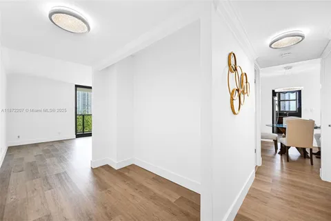 a view of a livingroom with wooden floor and furniture