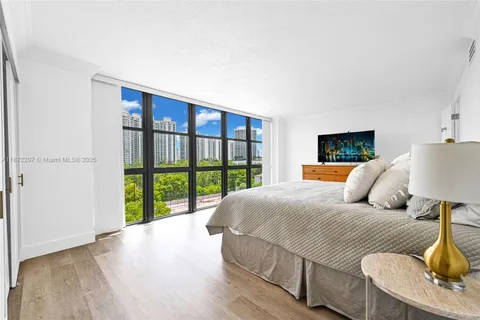 a bedroom with a large bed and a large window
