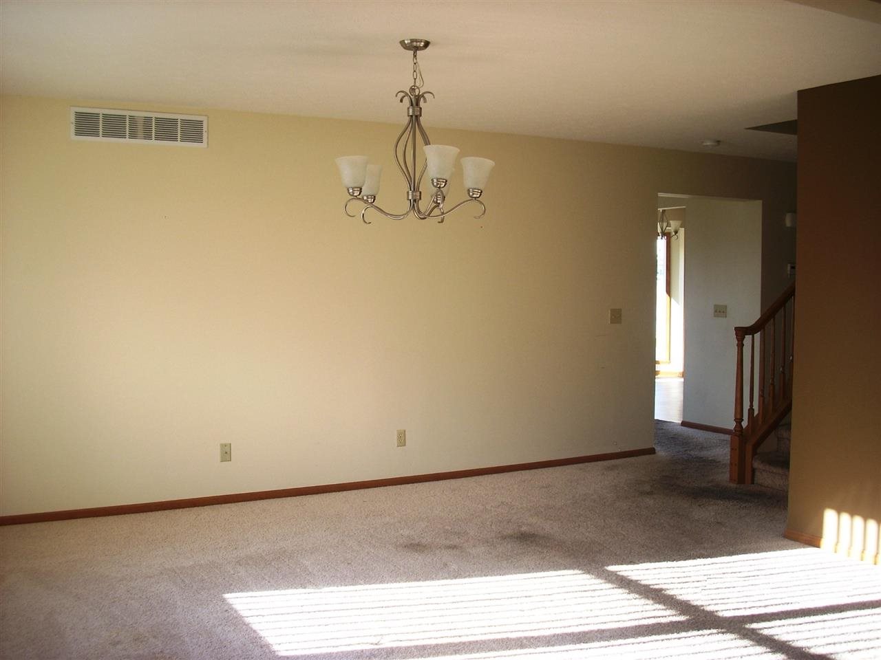 11090 Chicory Ridge Way Roscoe, IL 61073 - Photo 3 of 17 a view of empty room with wooden floor and fan
