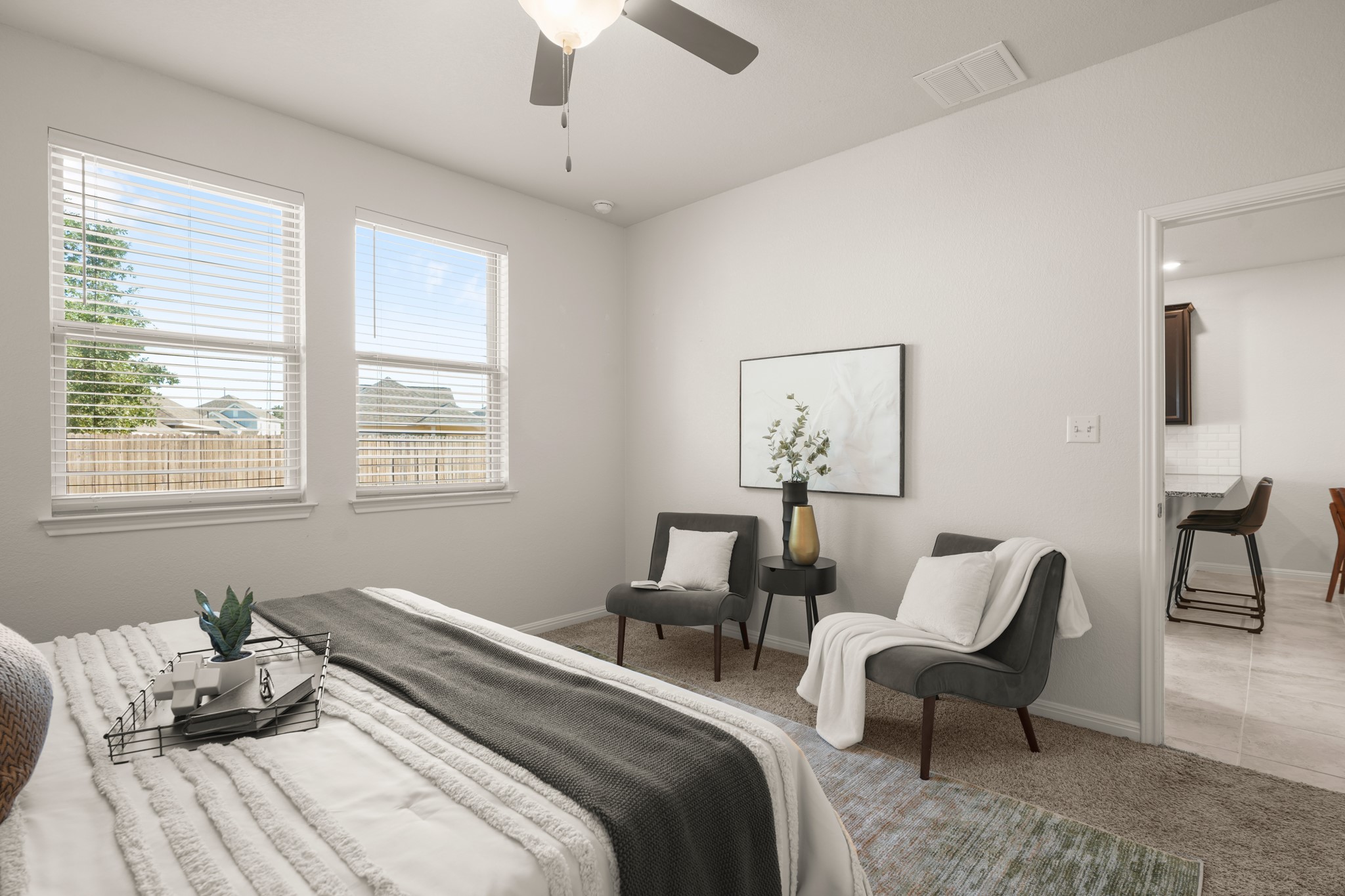 152 Mountain Valley Street Georgetown, TX 78628 - Photo 11 of 38 Double windows frame neighborhood views in this light-filled bedroom featuring soft carpet flooring.