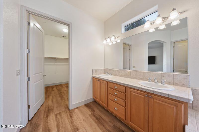 9900 Wilbur May Parkway, Unit 2501 Reno, NV 89521 - Photo 15 of 37 a spacious bathroom with a granite countertop double vanity sink a mirror and a shower