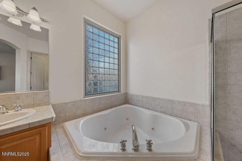 9900 Wilbur May Parkway, Unit 2501 Reno, NV 89521 - Photo 17 of 37 a bathroom with a bathtub and a sink