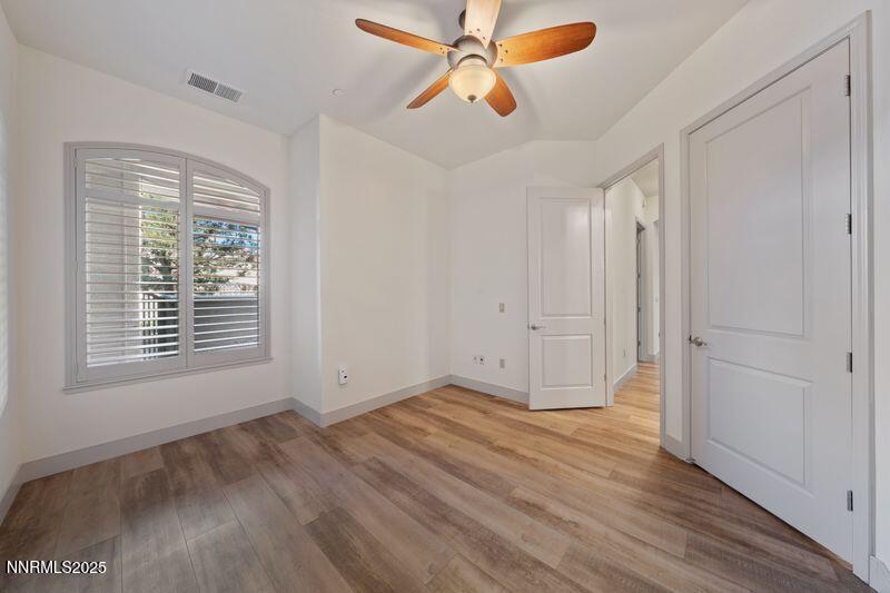 9900 Wilbur May Parkway, Unit 2501 Reno, NV 89521 - Photo 21 of 37 a view of an empty room with wooden floor and a window