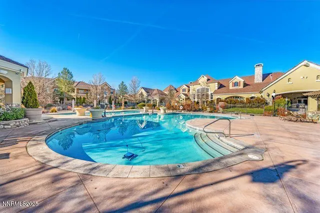 an aerial view of residential house with an outdoor space and seating
